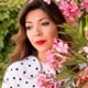 a woman next to flowers